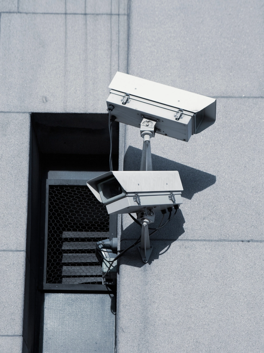 Security cameras mounted on the exterior wall of a building.